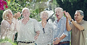Face, garden and old people blowing confetti, hug and happiness with retirement, sunshine and bonding together. Portrait