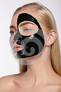 The face of the girl with black mask on her face.