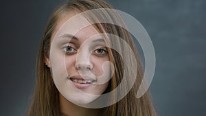 face girl a close-up. portrait of lifestyle a teenager girl smiling beautiful eyes blonde at home indoors. face of a