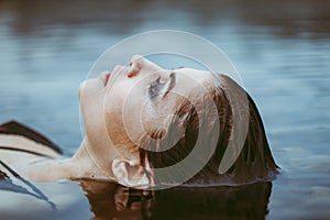 face girl lying in the water