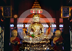 Face of golden Buddha, golden image of Buddha inside the temple
