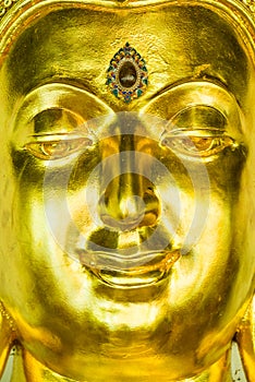 Face of golden buddha sculpture