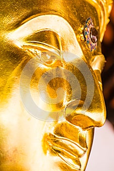 Face of golden buddha sculpture