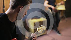 Face and Hand of an Electric Guitar Player