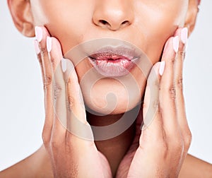Face, hands and lips with a woman closeup in studio on a white background for beauty, skincare or natural cosmetics
