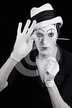 Face and hands of mime with dark make-up