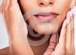 Face, hands and mouth with a woman closeup in studio on a white background for beauty, skincare or natural cosmetics