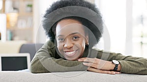 Face of a happy afro woman relaxing indoors on the weekend. Beautiful, cheerful and carefree African American girl