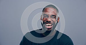 Face, happy or black man laughing at joke or crazy comedy in studio isolated on gray background. Funny, African model or
