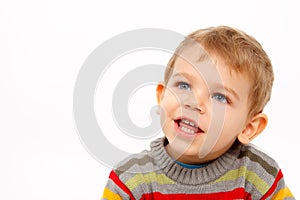 Face of happy boy in winter clothes looking up