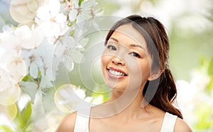 Face of happy smiling young asian woman