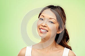 Face of happy smiling young asian woman