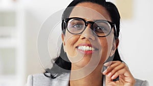Face of happy smiling young woman in glasses