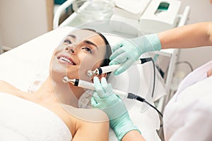 Face of happy woman during the microcurrent therapy