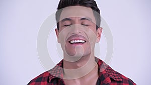 Face of happy young Hispanic hipster man relaxing with eyes closed