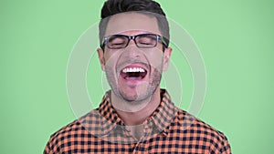 Face of happy young Hispanic hipster man smiling and laughing