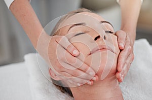 The face has muscles like the rest of the body. a woman receiving a facial massage while at a spa.