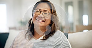 Face, home and Asian woman on a couch, smile and relax with retirement, happy and peace in a living room. Japanese