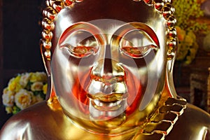 Face image of Golden Buddha statue at Thai temple