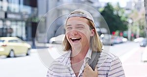 Face, laughing and man in street, happy and outdoor in urban town, metro road or sidewalk. Portrait, funny student in