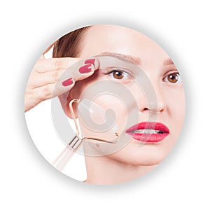 Face lift anti-aging treatment with jade roller. Woman with perfect skin of her face after massage