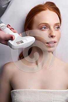 Face lifting by ultrasound using a special cosmetology device photo