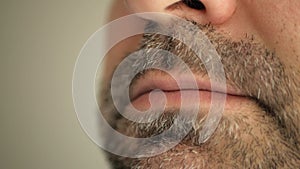 Face, lips of a man with a gray beard. Super macro close-up.