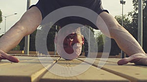 Face of a man doing headstand in the park