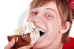 Face of man eating cake.
