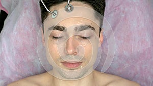 Face of man, microcurrent therapy.