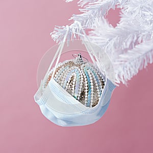 Face mask and ball on a christmas tree