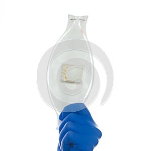 Face mask in doctor hand in medical glove isolated