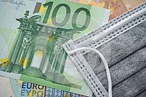 Face mask on Euro banknotes bill background. Global novel coronavirus Covid-19 outbreak effect to EU, world economy, financial