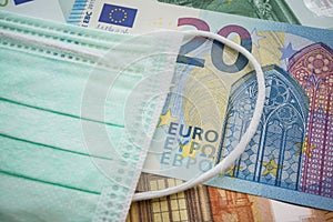 Face mask on Euro banknotes bill background. Global novel coronavirus Covid-19 outbreak effect to EU, world economy, financial