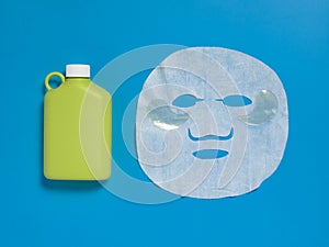 Face mask , reusable nwater bottle, cucumber, notepad on blue background. Dehydration.