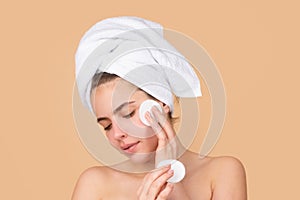 Face mask, spa beauty treatment, skincare. Woman facial care. Beautiful young woman touching cheek with sponge. Portrait