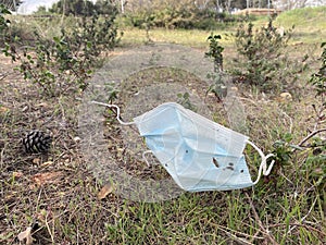 Face mask thrown in the field. Pollution. Uncivil behavior