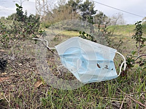 Face mask thrown in the field. Pollution. Uncivil behavior