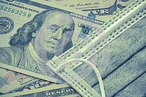 Face mask on US dollar bill banknote background. Global novel coronavirus Covid-19 outbreak effect to world economy, financial