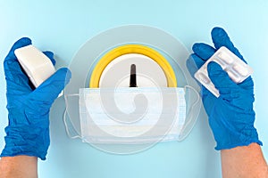 Face  mask, yellow clock, blue nitrile gloves, paracetemol, soap shot on a blue background