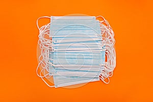 Face masks with ear loops. Three-layer protective medical masks on a colored background.
