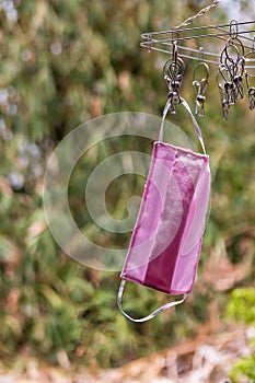 face masks hanging for reuse include of medical mask and cloth mask and construction mask. Concept of efficacy