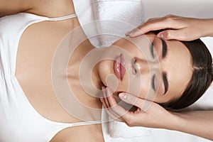 Face massage. Beautiful of young woman getting spa massage treatment at beauty spa salon.Spa skin and body care.