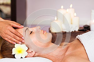 Face Massage. Close-up of a beautiful Woman Getting Spa Treatment.