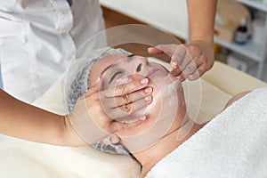 Face massage. Close-up of woman getting spa massage treatment at beauty spa salon. Spa skin and body care.