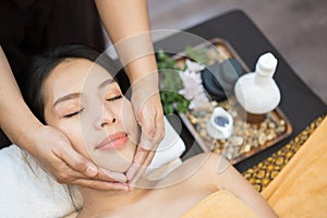 Face massage. Close-up of young woman getting spa massage treatment at beauty spa salon. Spa skin and body care. Facial beauty