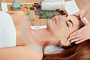 Face massage. Close-up of young woman getting spa massage treatment at beauty spa salon.Spa skin and body care of female.