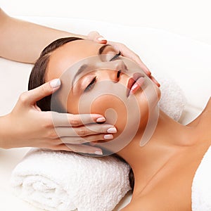 Face Massage. Close-up of a Young Woman Getting Spa Treatment. photo