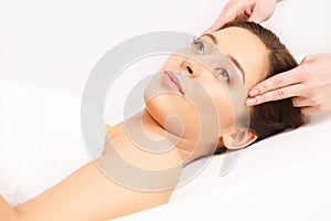 Face Massage. Close-up of a Young Woman Getting Spa Treatment.