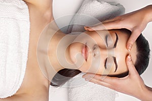 Face massage.  Close-up of young woman getting spa massage treatment at beauty spa salon.Spa skin and body care. Facial beauty